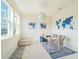 Bright office features a world map on the wall, a modern light fixture, and large windows at 28923 Lucero Ln, Wesley Chapel, FL 33543
