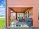 Covered patio with outdoor seating, a gas fire pit, a grill, and views of the pond and backyard at 28923 Lucero Ln, Wesley Chapel, FL 33543