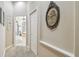 Hallway with a view to the main bathroom, featuring neutral tones and decorative wall art at 3040 Olivia Ct, Land O Lakes, FL 34638