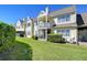 Charming townhome featuring a private balcony, screened lanai, and lush green lawn at 3506 Pine Knot Dr, Valrico, FL 33596