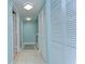 A bright hallway with ample closet space, laundry and light tile flooring at 3506 Pine Knot Dr, Valrico, FL 33596