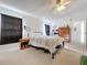 Bright bedroom featuring a ceiling fan, plush carpeting, and a large window for natural light at 3914 41St W St, Bradenton, FL 34205