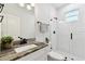 Bathroom featuring a modern vanity, granite countertop, and a walk-in shower with white subway tile at 4036 56Th N Ave, St Petersburg, FL 33714