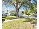 Inviting single-Gathering home with mature trees, long driveway and well-manicured front lawn at 4036 56Th N Ave, St Petersburg, FL 33714