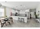 Modern kitchen featuring white cabinets, black countertops, stainless steel appliances, and bar seating at 4036 56Th N Ave, St Petersburg, FL 33714