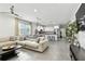 Open living room and kitchen area with neutral tones, tile floors, recessed lights and lots of natural light at 4036 56Th N Ave, St Petersburg, FL 33714