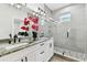 This bathroom boasts a double sink vanity with granite counters, mirrors, and glass-enclosed shower at 4036 56Th N Ave, St Petersburg, FL 33714