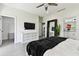 Bright main bedroom featuring a large mirror, a TV, backyard access, and ensuite bathroom at 4036 56Th N Ave, St Petersburg, FL 33714