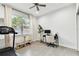 Bright office with a ceiling fan, a window, computer desk, a treadmill and tile floors at 4036 56Th N Ave, St Petersburg, FL 33714