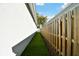 Side yard featuring green grass and a wooden privacy fence at 4036 56Th N Ave, St Petersburg, FL 33714