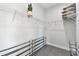 Walk-in closet features wire shelving and racks, and neutral grey walls at 4036 56Th N Ave, St Petersburg, FL 33714