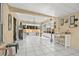 Bright sun room featuring white tile flooring, lots of windows and views to the exterior yard, and decorative accents at 4701 Kelly Rd, Tampa, FL 33615