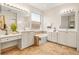 Bathroom with double vanity, bathtub, and decorative mirrors at 4949 Sandy Brook, Wimauma, FL 33598