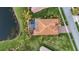 Stunning aerial view of a home with a private pool, lush landscaping, and a serene lake at 5073 Stone Harbor Cir, Wimauma, FL 33598