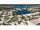 Community aerial view showcasing homes, landscaping, and sparkling lake at 5073 Stone Harbor Cir, Wimauma, FL 33598