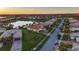 Scenic aerial view of a residential area with single-Gathering homes, peaceful lake, and stunning landscape at 5073 Stone Harbor Cir, Wimauma, FL 33598