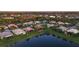 Aerial view of a residential neighborhood featuring single-Gathering homes surrounding a lake at 5073 Stone Harbor Cir, Wimauma, FL 33598
