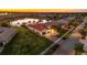 Aerial view of landscaped property with tile roof overlooking the lake at 5073 Stone Harbor Cir, Wimauma, FL 33598