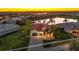 Stunning aerial view of landscaped property with tile roof and three-car garage overlooking the lake at 5073 Stone Harbor Cir, Wimauma, FL 33598