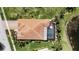 Overhead view of home with tile roof, enclosed pool, and green lawn at 5073 Stone Harbor Cir, Wimauma, FL 33598