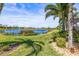 Well-maintained backyard featuring a lush lawn and serene lake view at 5073 Stone Harbor Cir, Wimauma, FL 33598