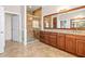 Spacious bathroom featuring a large vanity with granite countertop and a glass-enclosed shower at 5073 Stone Harbor Cir, Wimauma, FL 33598