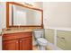Powder room featuring custom vanity with granite countertop and decorative mirror at 5073 Stone Harbor Cir, Wimauma, FL 33598
