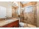 Bathroom featuring a glass enclosed shower with tile surround, and granite countertop vanity at 5073 Stone Harbor Cir, Wimauma, FL 33598