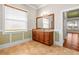 Bathroom showing the granite countertop, wooden cabinets, and a large window for natural light at 5073 Stone Harbor Cir, Wimauma, FL 33598