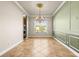 Traditional dining room with decorative chandelier, wainscoting and a large window at 5073 Stone Harbor Cir, Wimauma, FL 33598
