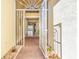 Open foyer with brick flooring, elegant security door, and views of the living area at 5073 Stone Harbor Cir, Wimauma, FL 33598