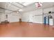 Spacious garage featuring overhead storage racks, providing ample space for vehicles and storage at 5073 Stone Harbor Cir, Wimauma, FL 33598