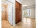 Open hallway leading to room with natural light, tile flooring, tall cabinet, and shower at 5073 Stone Harbor Cir, Wimauma, FL 33598