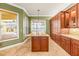 Bright kitchen features granite countertops, ample cabinetry, and views of the lake from the window at 5073 Stone Harbor Cir, Wimauma, FL 33598