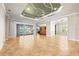 Open living room with decorative ceiling, tile floors, and sliding doors to the patio at 5073 Stone Harbor Cir, Wimauma, FL 33598