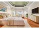Inviting main bedroom featuring tray ceiling, bay window, and stylish furnishings at 5073 Stone Harbor Cir, Wimauma, FL 33598