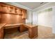Home office featuring custom cabinetry, granite countertops, and a built-in desk area at 5073 Stone Harbor Cir, Wimauma, FL 33598