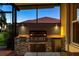 Outdoor kitchen includes stainless steel grill, mini fridge, and ample counter space at 5073 Stone Harbor Cir, Wimauma, FL 33598