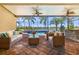 Covered patio featuring outdoor seating, a summer kitchen, ceiling fans and views of the pool at 5073 Stone Harbor Cir, Wimauma, FL 33598