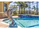 Close-up of screened-in pool area with dolphin fountain and tile detailing at 5073 Stone Harbor Cir, Wimauma, FL 33598