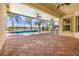 Screened-in outdoor space with a pool, hot tub, summer kitchen, and tile patio at 5073 Stone Harbor Cir, Wimauma, FL 33598