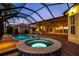 Beautiful backyard pool and spa with a screened enclosure, outdoor kitchen and covered patio at 5073 Stone Harbor Cir, Wimauma, FL 33598