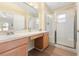 This primary bathroom has a large vanity, double sinks, and glass enclosed shower at 5105 Gato Del Sol Cir, Wesley Chapel, FL 33544