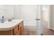 This bathroom features a shower-tub combo with tile surround and wood-look floors at 5105 Gato Del Sol Cir, Wesley Chapel, FL 33544