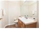 This half bath has a wood vanity, light paint, and a bright, white sink at 5105 Gato Del Sol Cir, Wesley Chapel, FL 33544