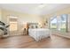 Bright bedroom with large windows, light walls, and wood-look flooring offers a serene living space at 5105 Gato Del Sol Cir, Wesley Chapel, FL 33544
