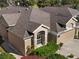 Elevated view of a home with a well-maintained lawn and trimmed garden, showcasing its design and curb appeal at 5105 Gato Del Sol Cir, Wesley Chapel, FL 33544