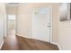 Open foyer featuring wood-look floors, neutral walls, and a view into other rooms of the home at 5105 Gato Del Sol Cir, Wesley Chapel, FL 33544