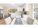 A well-lit kitchen with stainless steel appliances, white cabinetry, and a dining area perfect for meals at 5105 Gato Del Sol Cir, Wesley Chapel, FL 33544