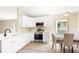 Well-lit kitchen boasting white cabinets, stainless steel appliances, and an adjacent dining area at 5105 Gato Del Sol Cir, Wesley Chapel, FL 33544